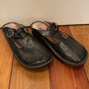 Black clogs with sliver accents. Leather lining.